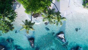 Person with backpack on a beach destination